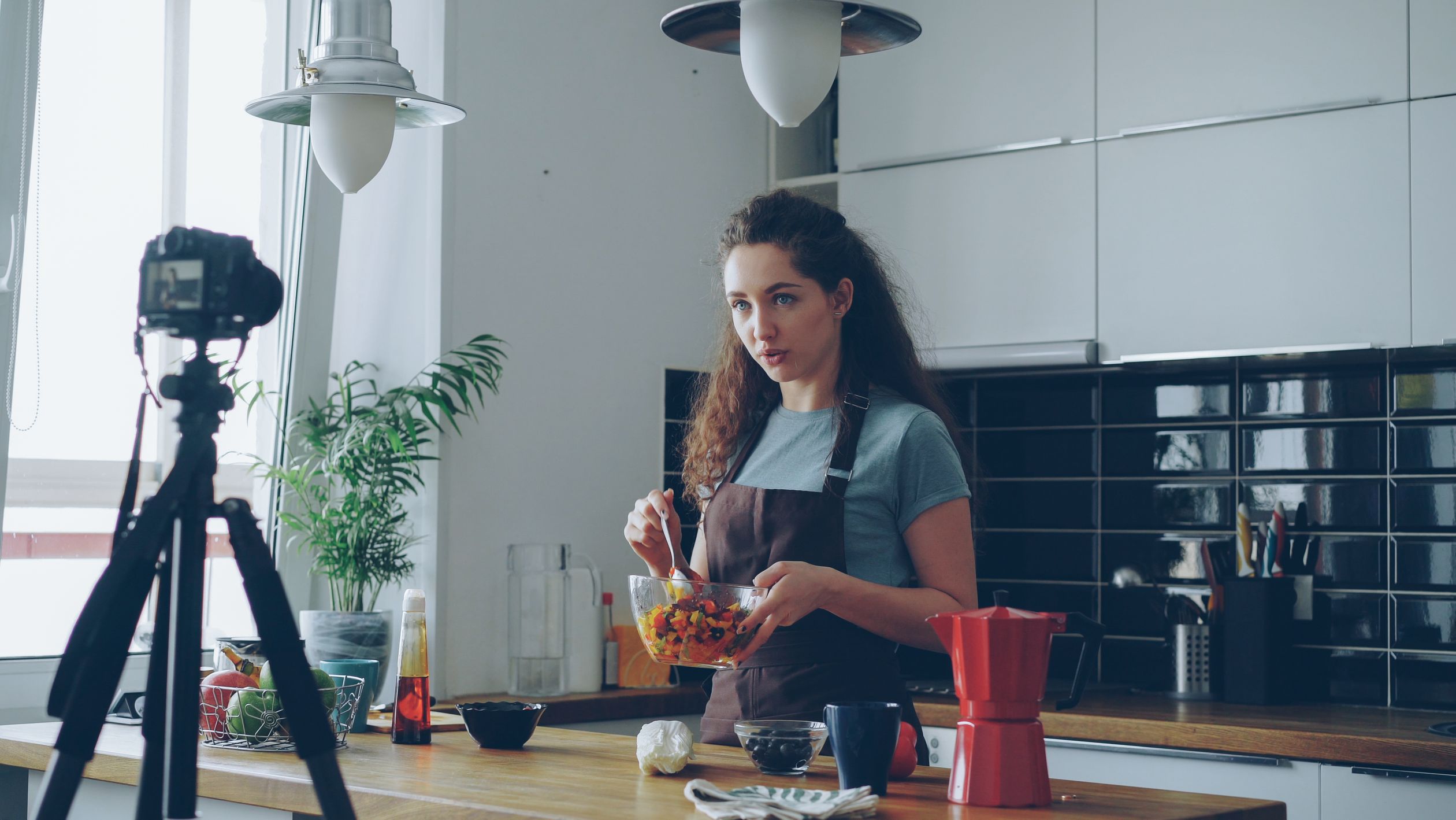Inlagim Cooking Tutorial Young Woman Filming Cooking Tutorial in Modern Kitchen · Free Stock Photo