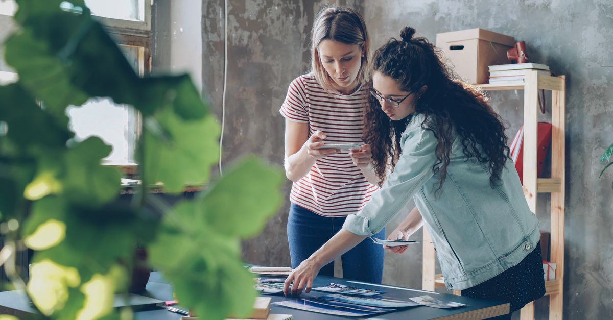 Two designers working together at a table in a stylish urban studio.
