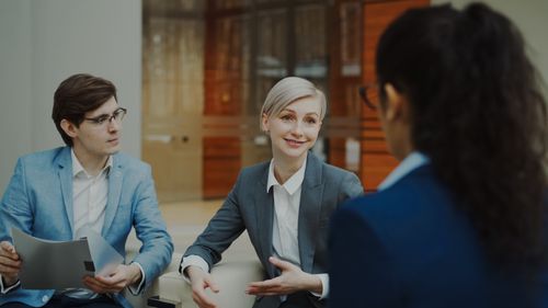 Free Group of professionals having a discussion in a modern office setting. Stock Photo