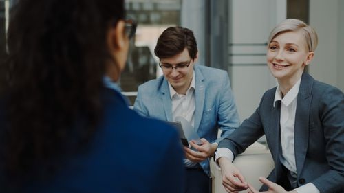 Free Three professionals engaged in a business meeting indoors. Stock Photo