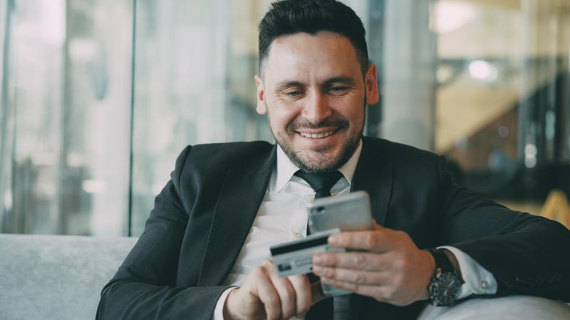 Businessman using credit card for online transaction
