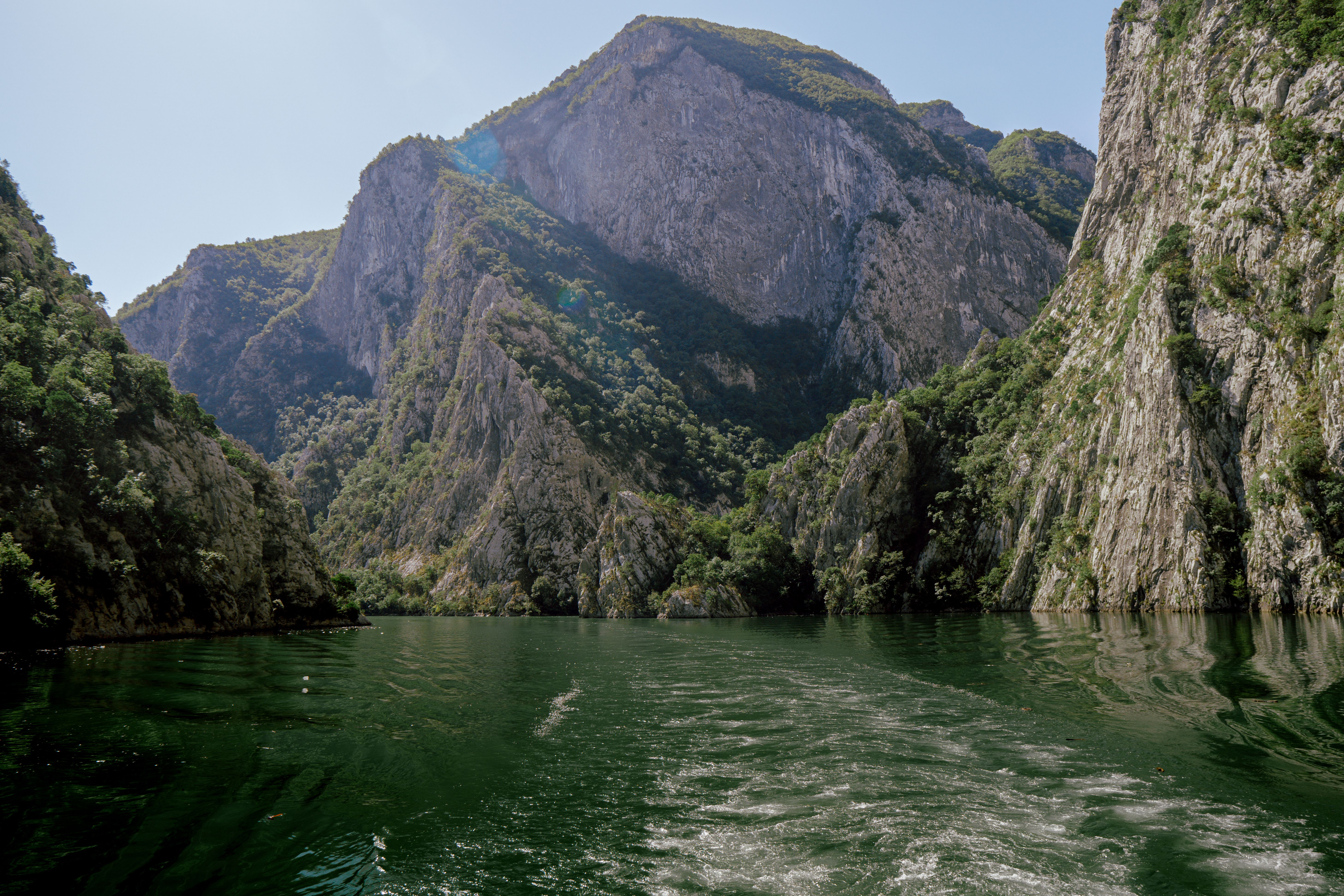 People kayaking on the calm waters of Matka Canyon in North Macedonia