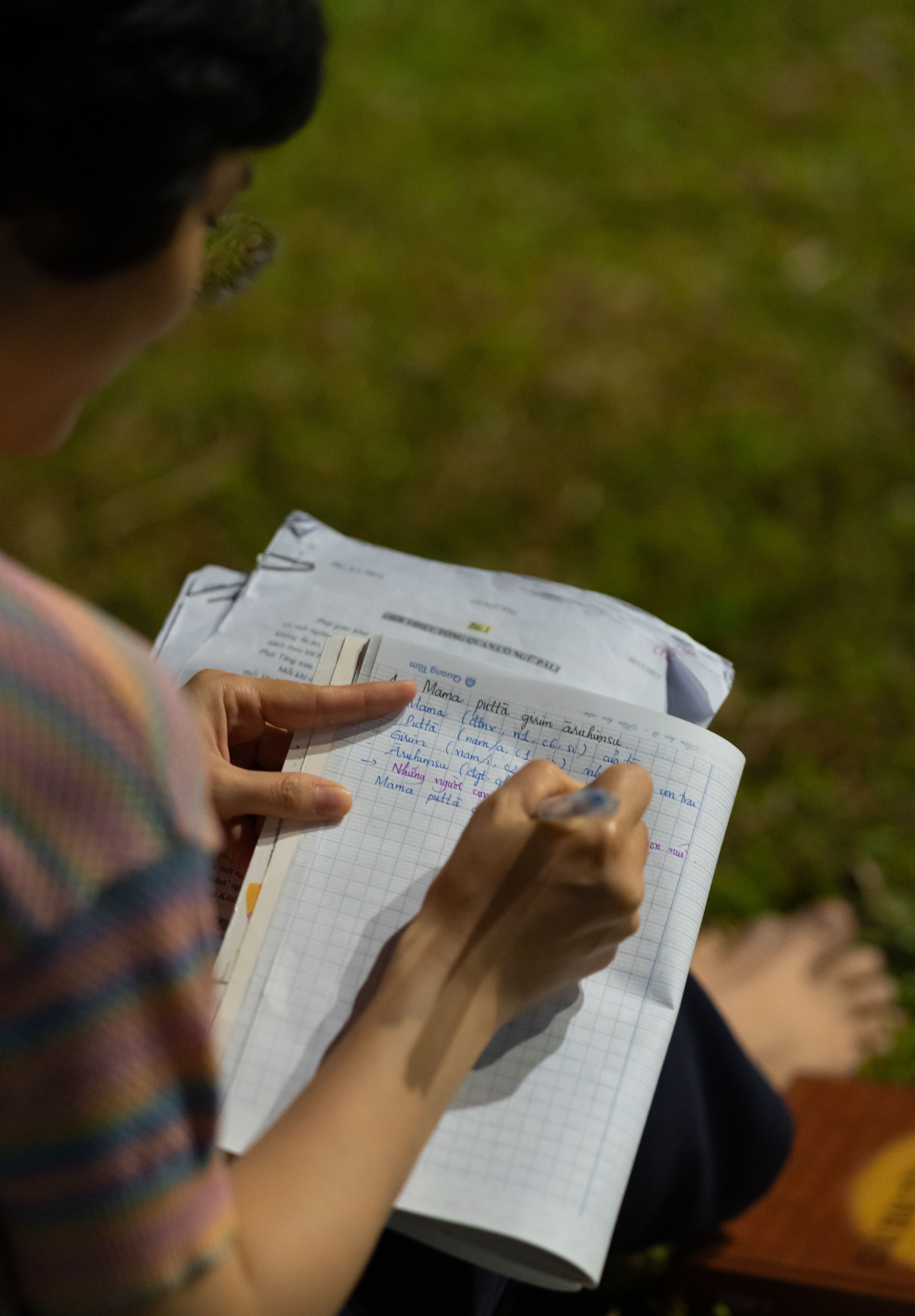 Person Writing Notes Outdoors in Notebook · Free Stock Photo