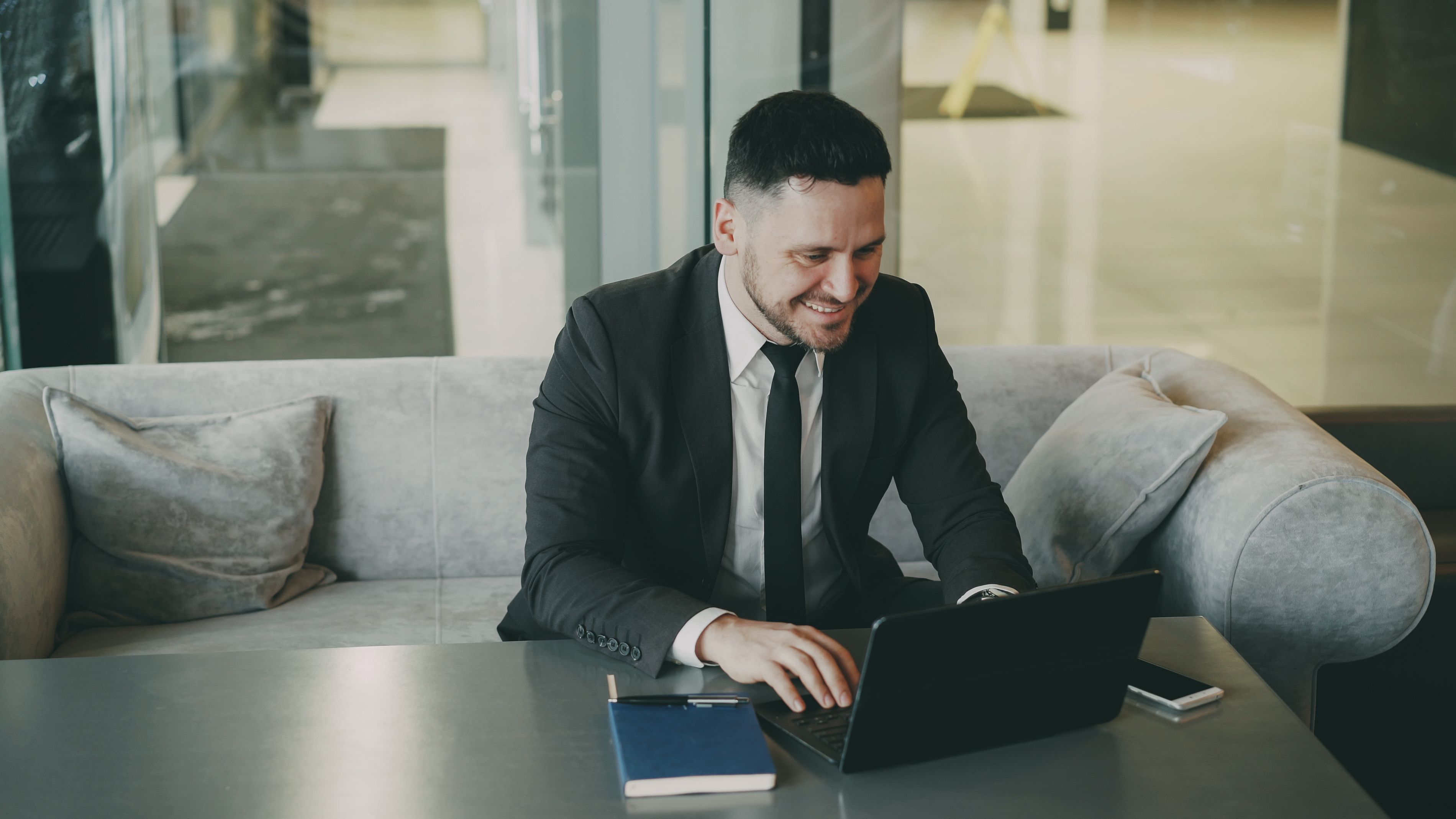 Professional man in suit using laptop at office, representing business success and workplace productivity.