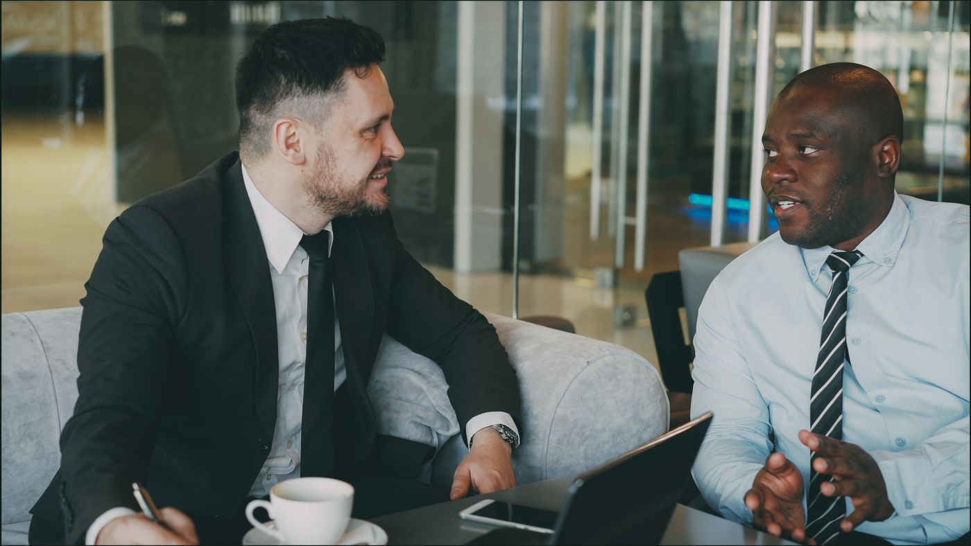 Two people comparing notes in a cafe