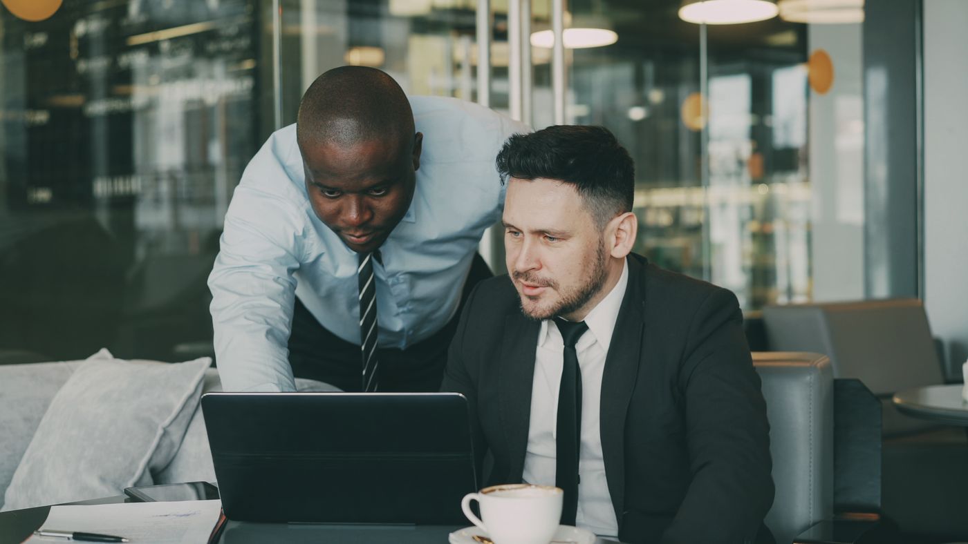 Two professionals working together at a laptop