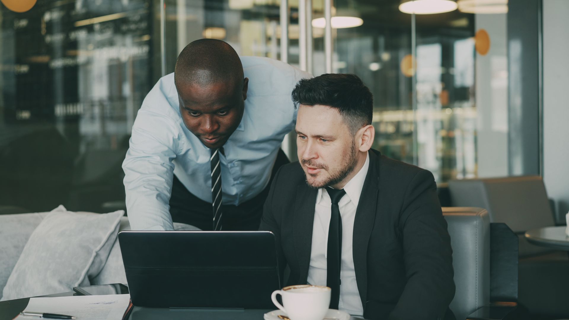 Business professionals collaborating on a laptop