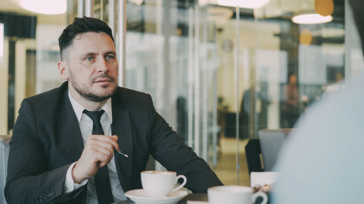 Professional business conversation over coffee