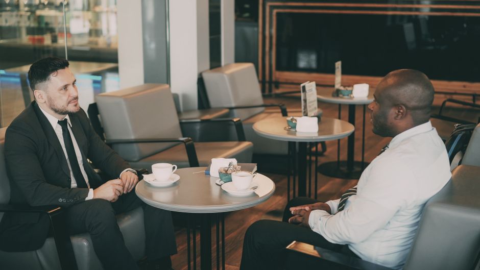 Two professionals in an informal meeting in a lounge cafe