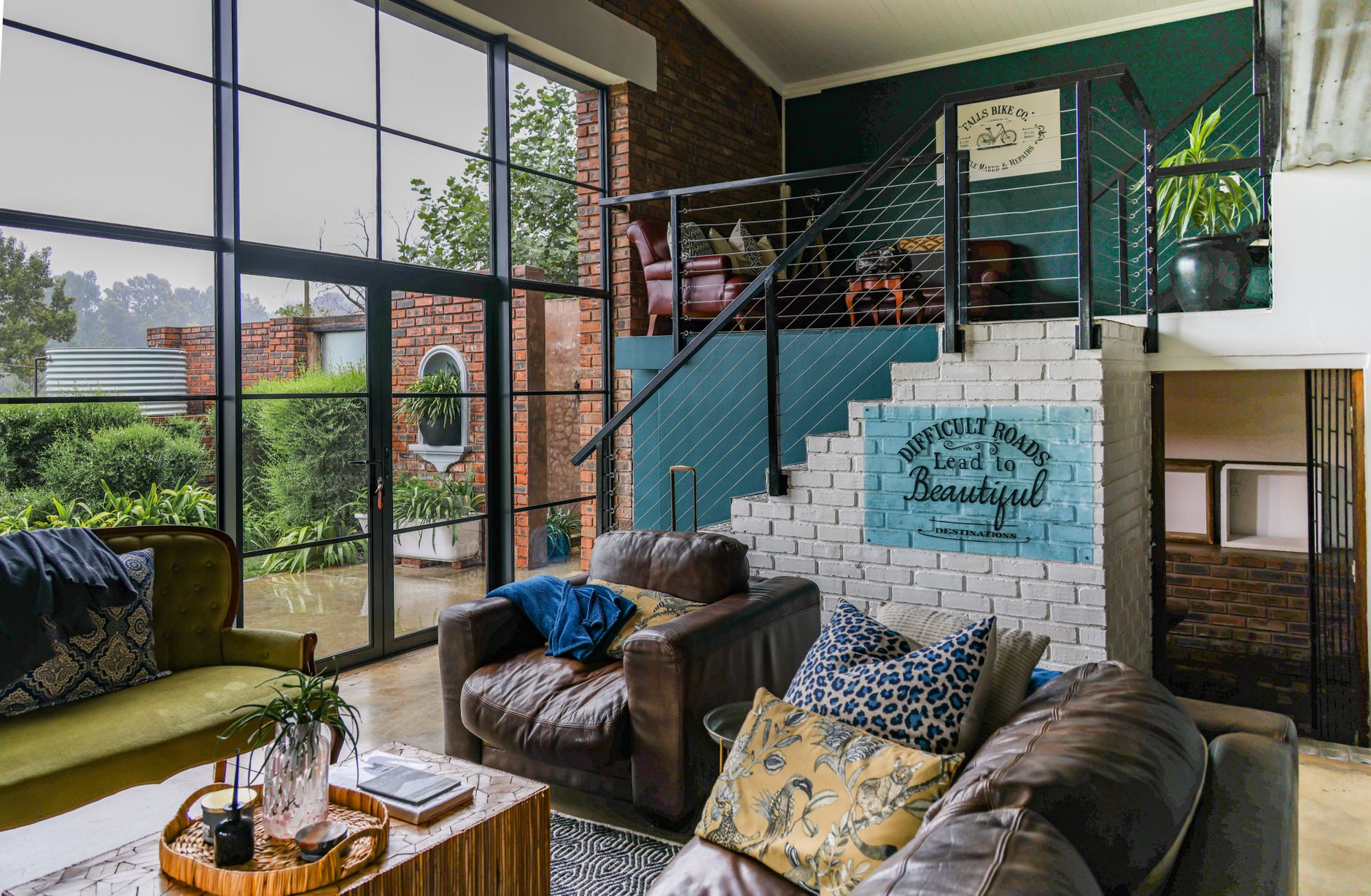 Stylish living room interior featuring large windows, modern decor, and a cozy seating area.