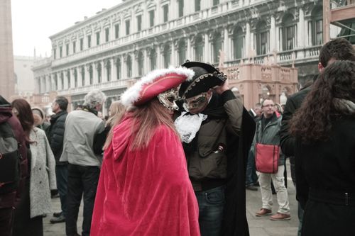 Free Colorful masks and costumes at the Venice Carnival, capturing the festive atmosphere in Piazza San Marco. Stock Photo