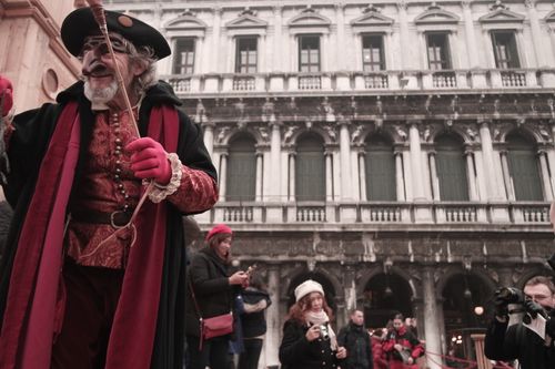 Free Carnival performer in Venice with traditional attire and dramatic mask, capturing the festive atmosphere. Stock Photo