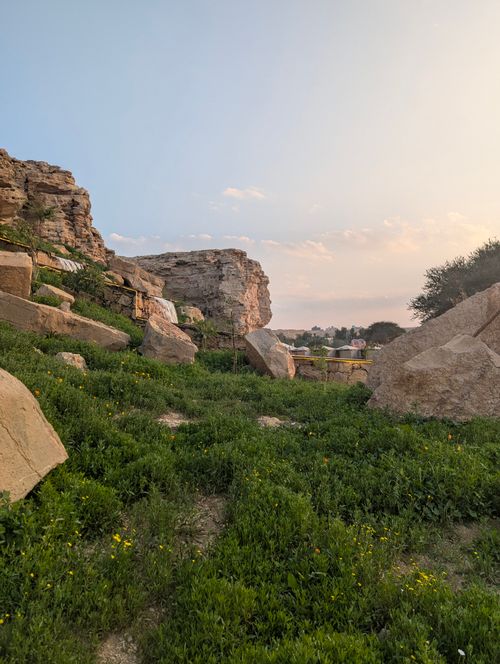 Free Explore the beauty of a rocky landscape at sunset with rich greenery and clear skies. Stock Photo