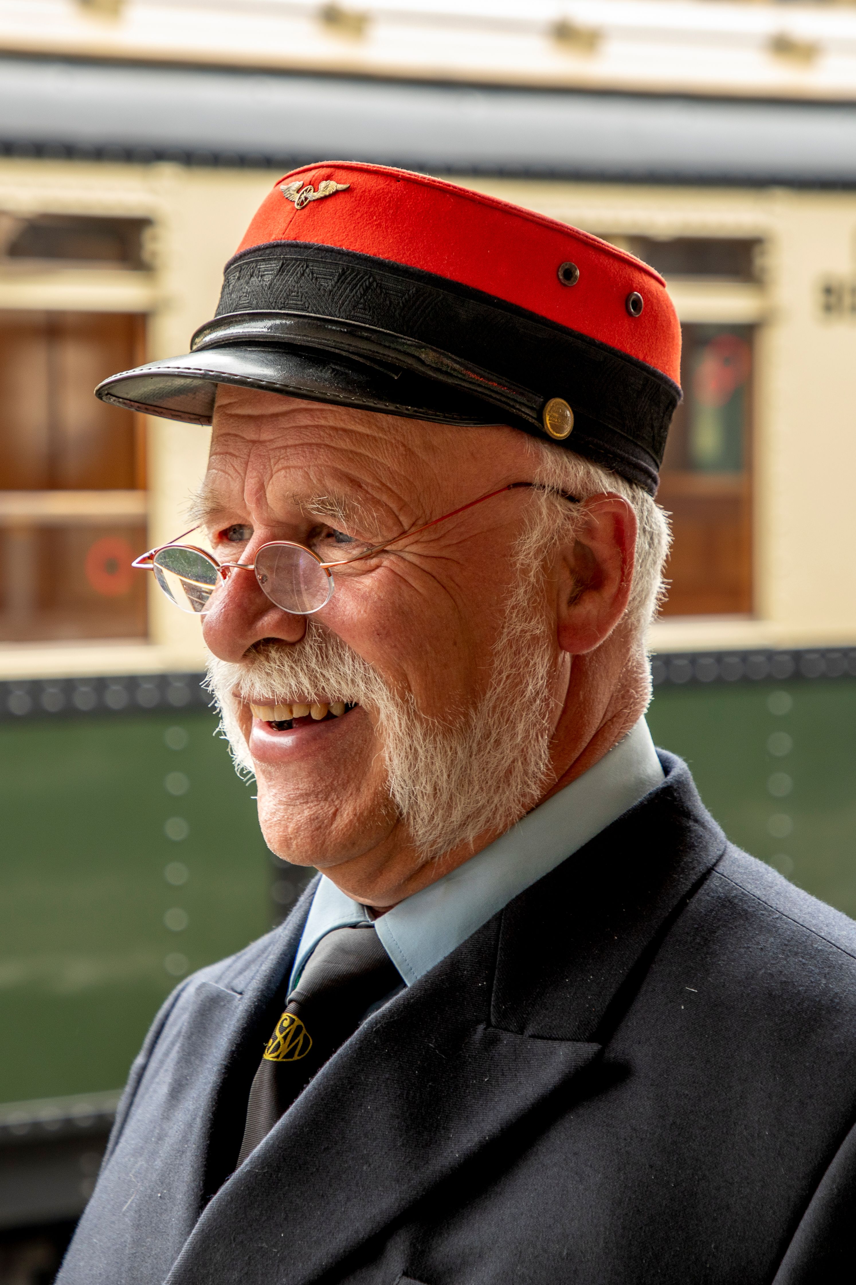 Portrait of a vintage train conductor at Baarn Station, Utrecht, in classic 19th-century attire.