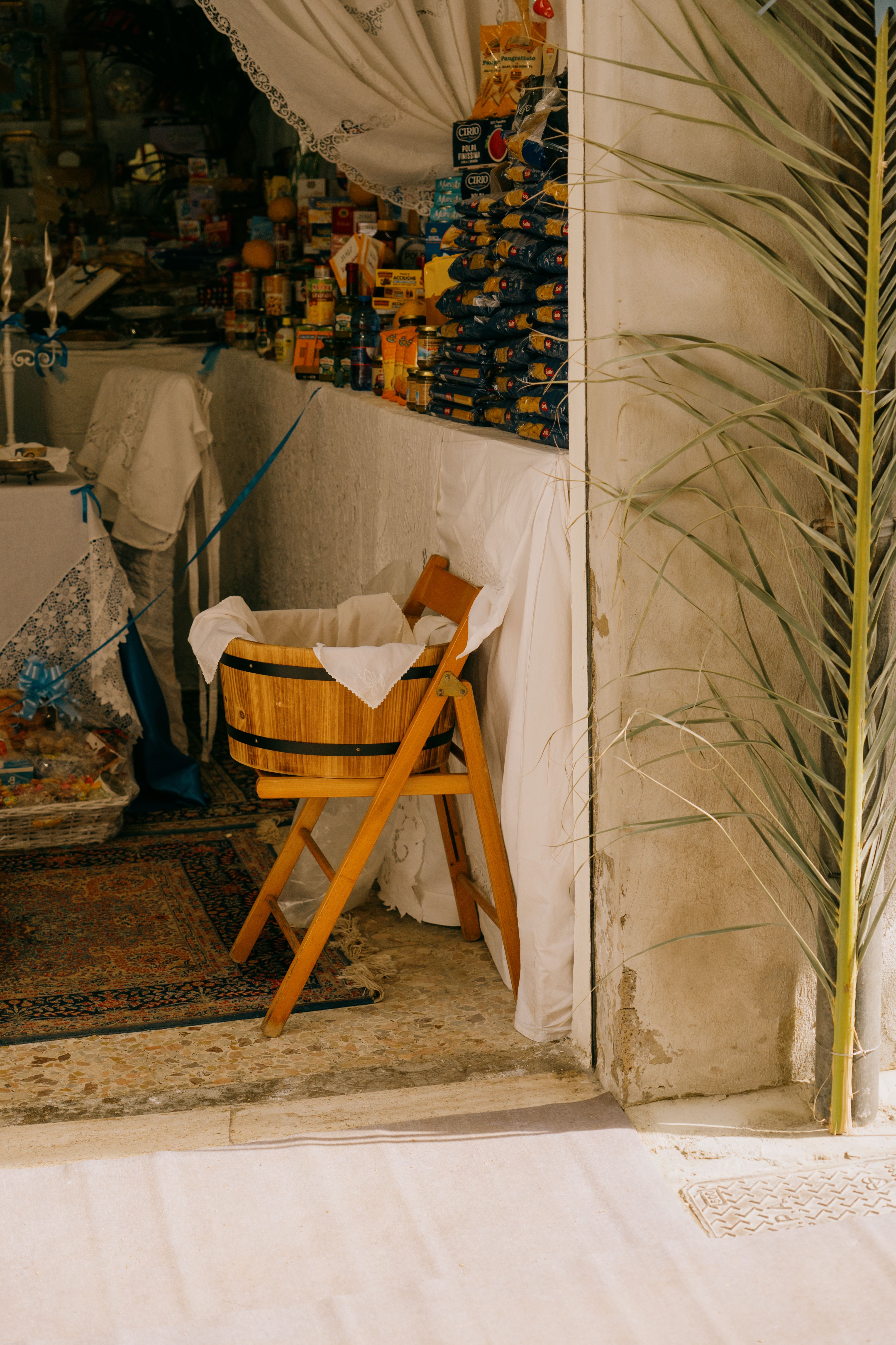 A cozy market stall in Gela, Sicilia, showcasing local goods and traditional decor.
