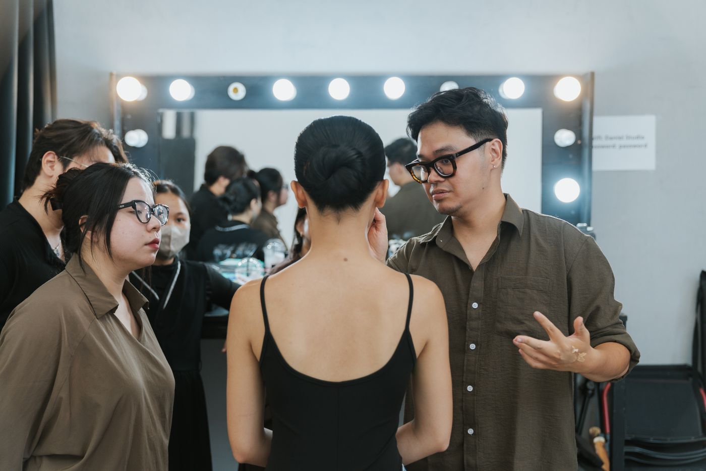 A team preparing models backstage before a show