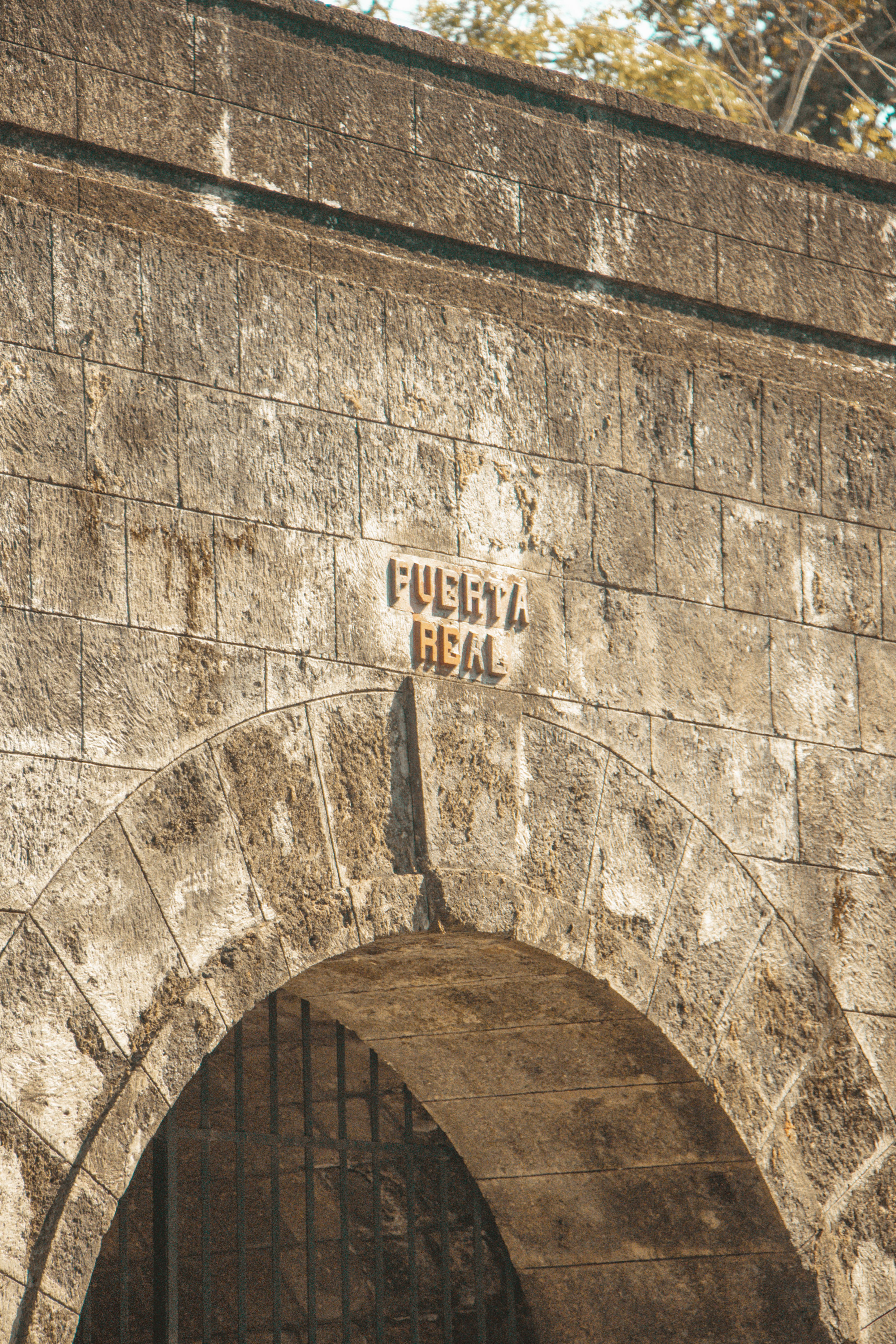 Photograph of the Puerta Real archway in Intramuros, showcasing historic stone architecture.