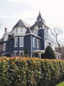Charming Victorian house with intricate details, surrounded by lush greenery in Newtown, PA.