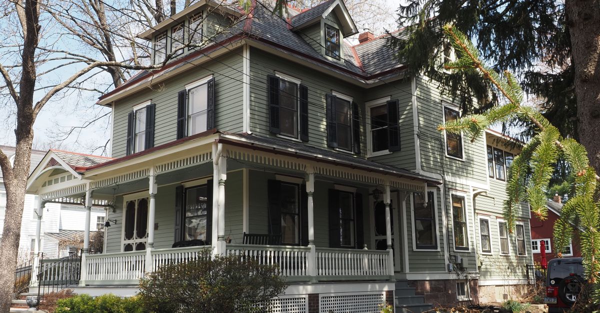 Beautiful Victorian house surrounded by trees in Newtown, Pennsylvania, during spring.