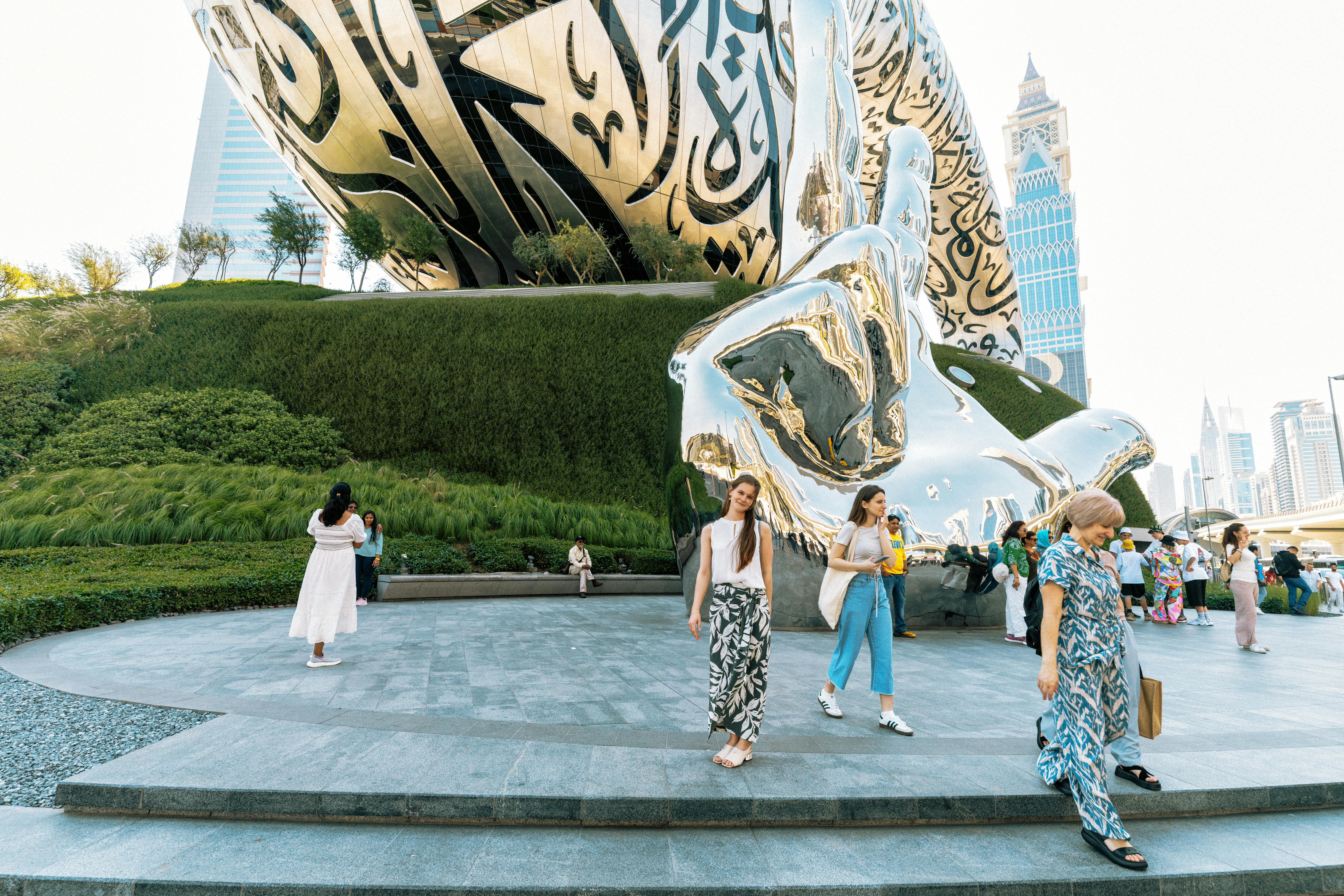 Tourists enjoying the iconic Museum of the Future in Dubai with modern architecture.