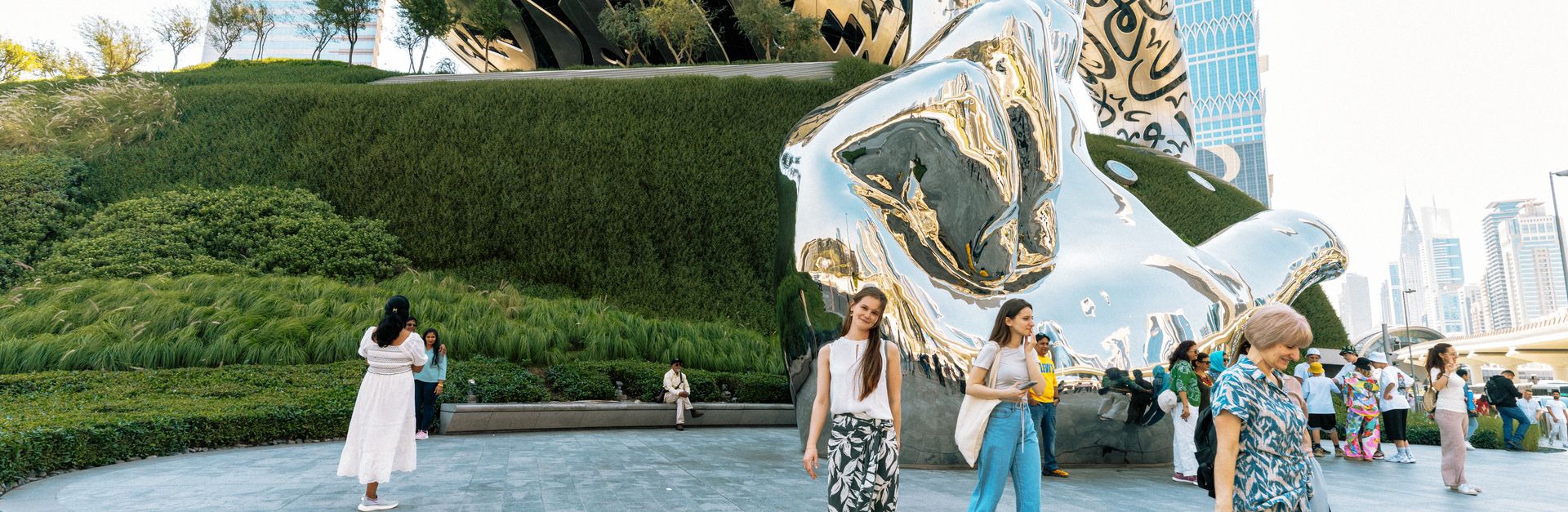 Tourists enjoying the iconic Museum of the Future in Dubai with modern architecture.