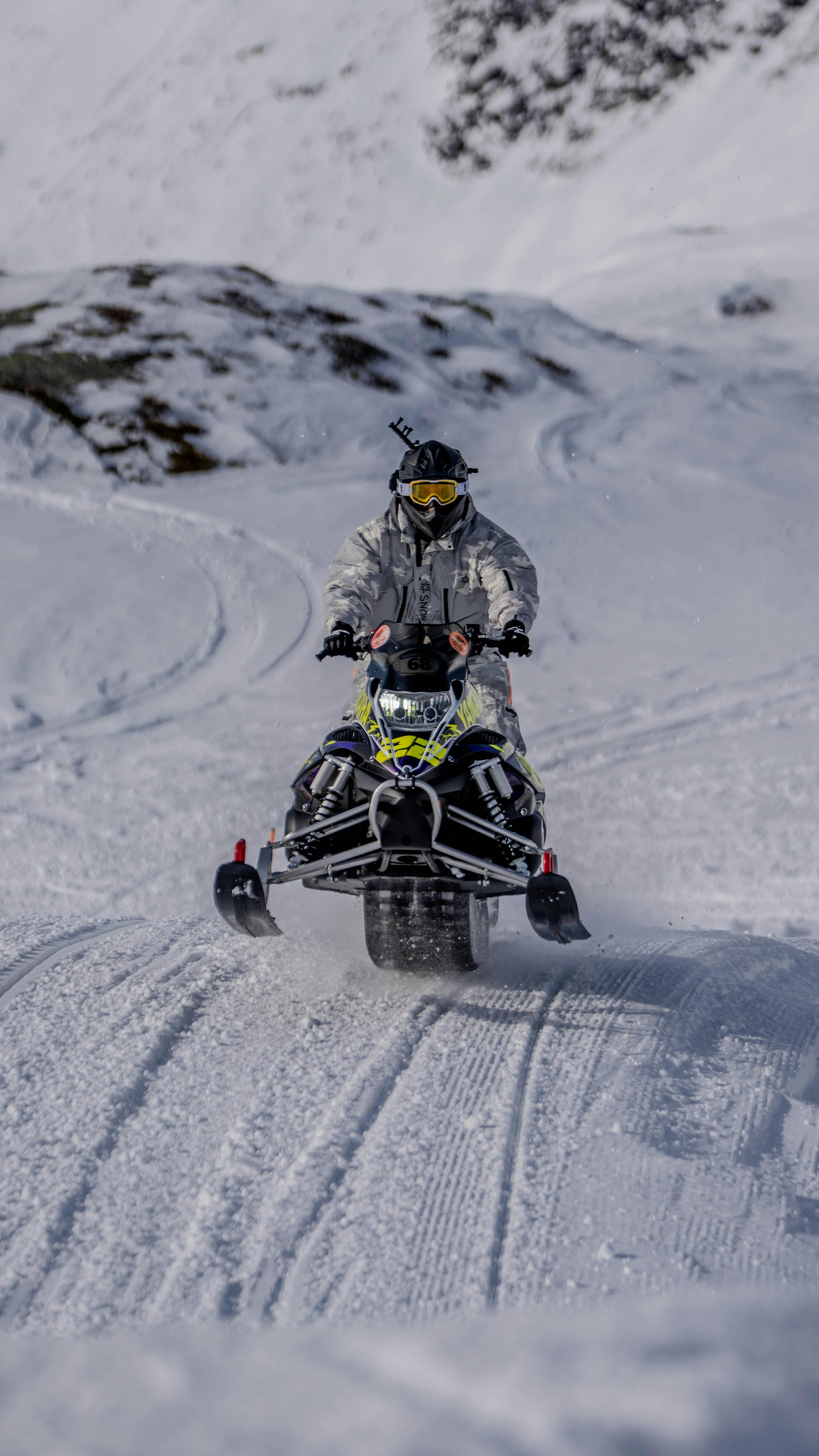 Thrilling snowmobile ride through snowy Madesimo landscape.