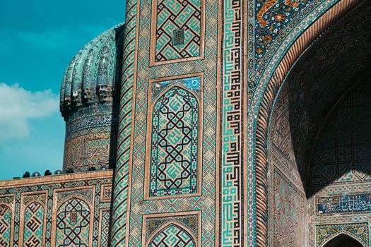 Detailed view of ornate mosaic patterns on Islamic architecture in Uzbekistan, showcasing historic design.