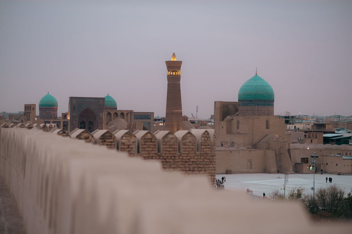 Minarets and turquoise domes on the Bukhara skyline at twilight, Uzbekistan
