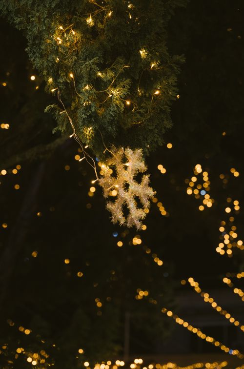 Free Close-up of holiday lights and snowflake decoration at night, evoking a festive and warm ambiance. Stock Photo