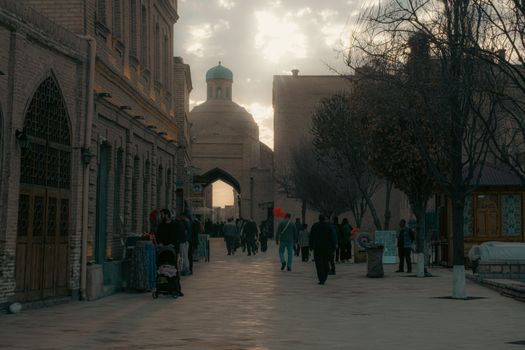A serene evening in the historic city of Bukhara, Uzbekistan, showcasing classic architecture and daily life.
