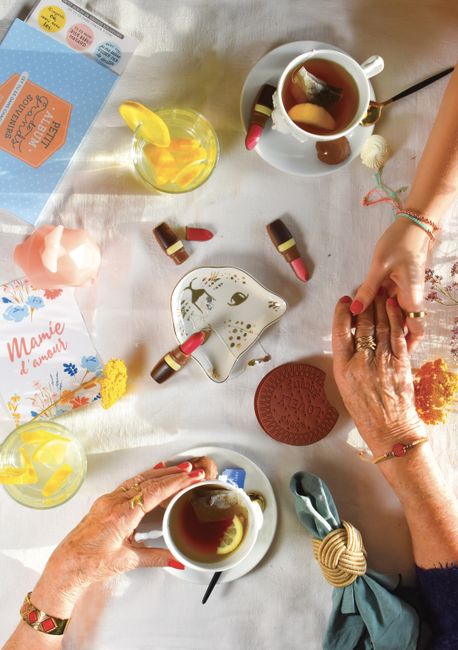 A heartwarming scene of a senior and child holding hands over tea, symbolizing love and connection.