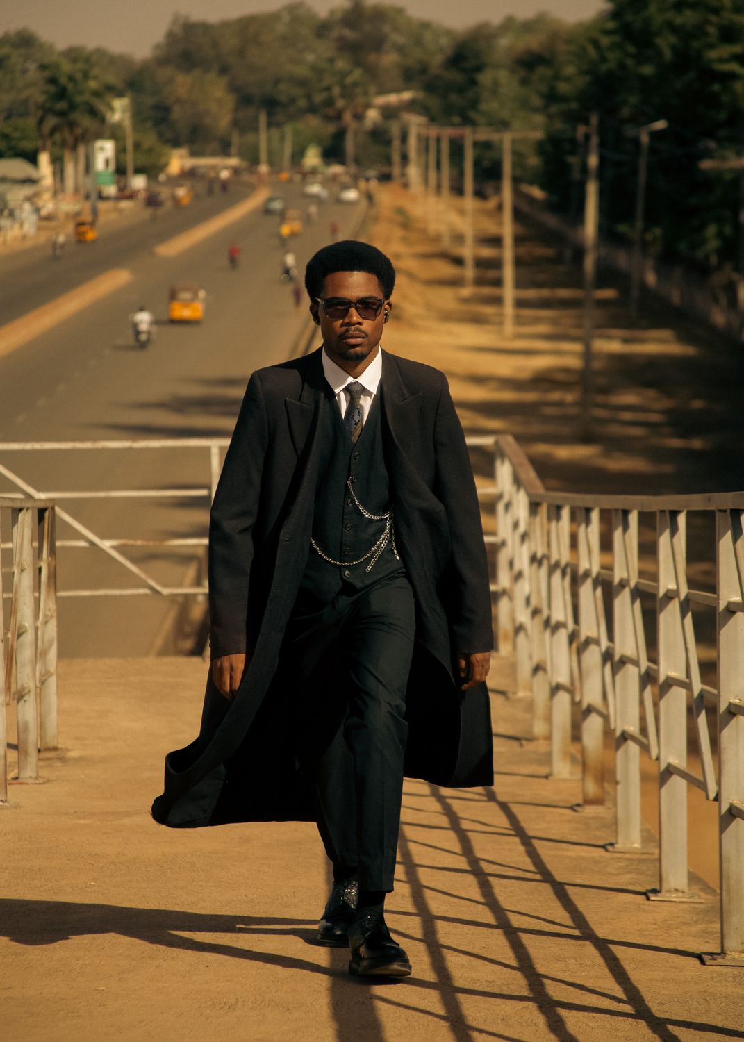 Stylish Man Walking on Urban Pedestrian Bridge · Free Stock Photo