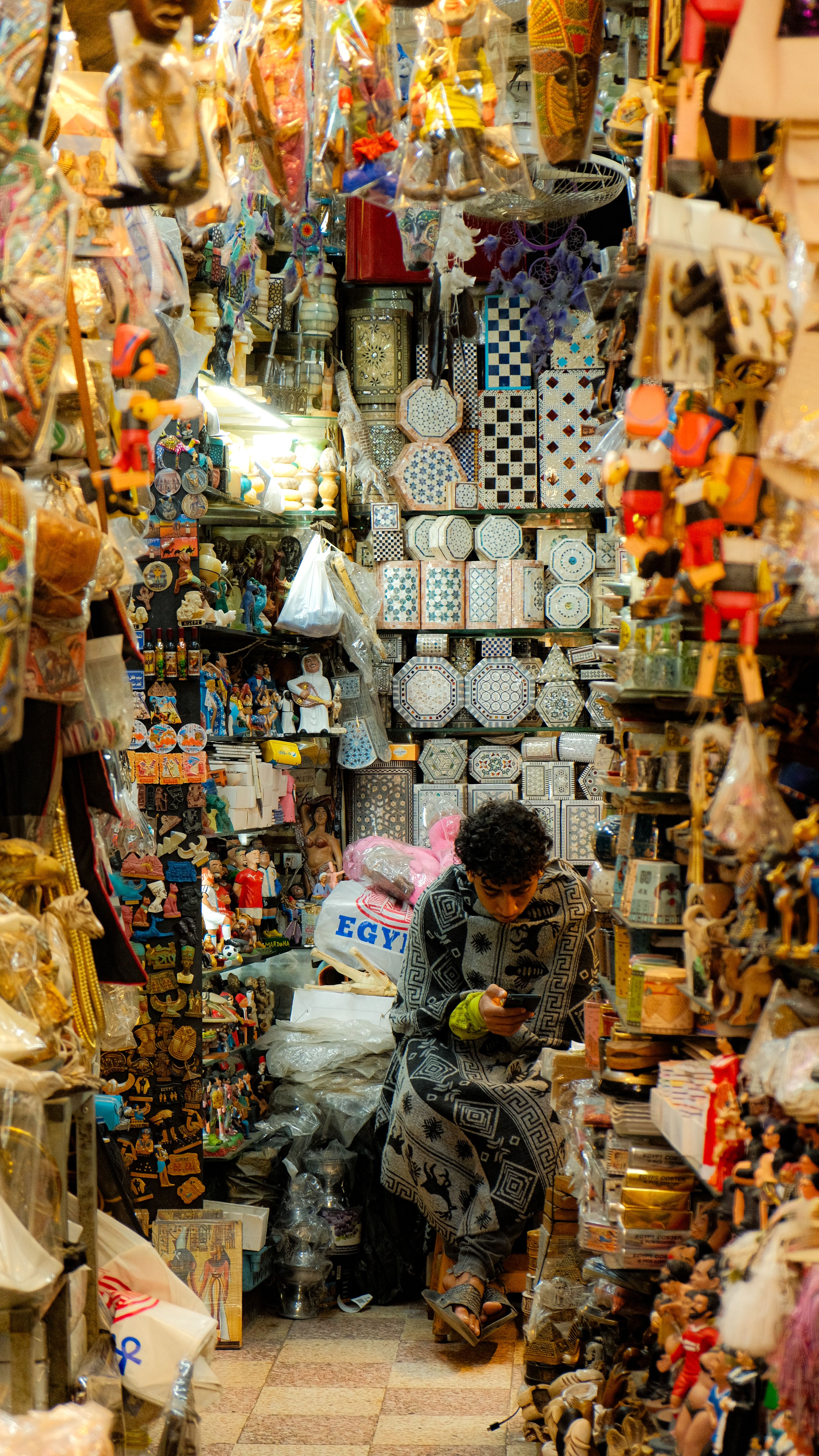 A vibrant market stall packed with colorful souvenirs and handmade crafts.