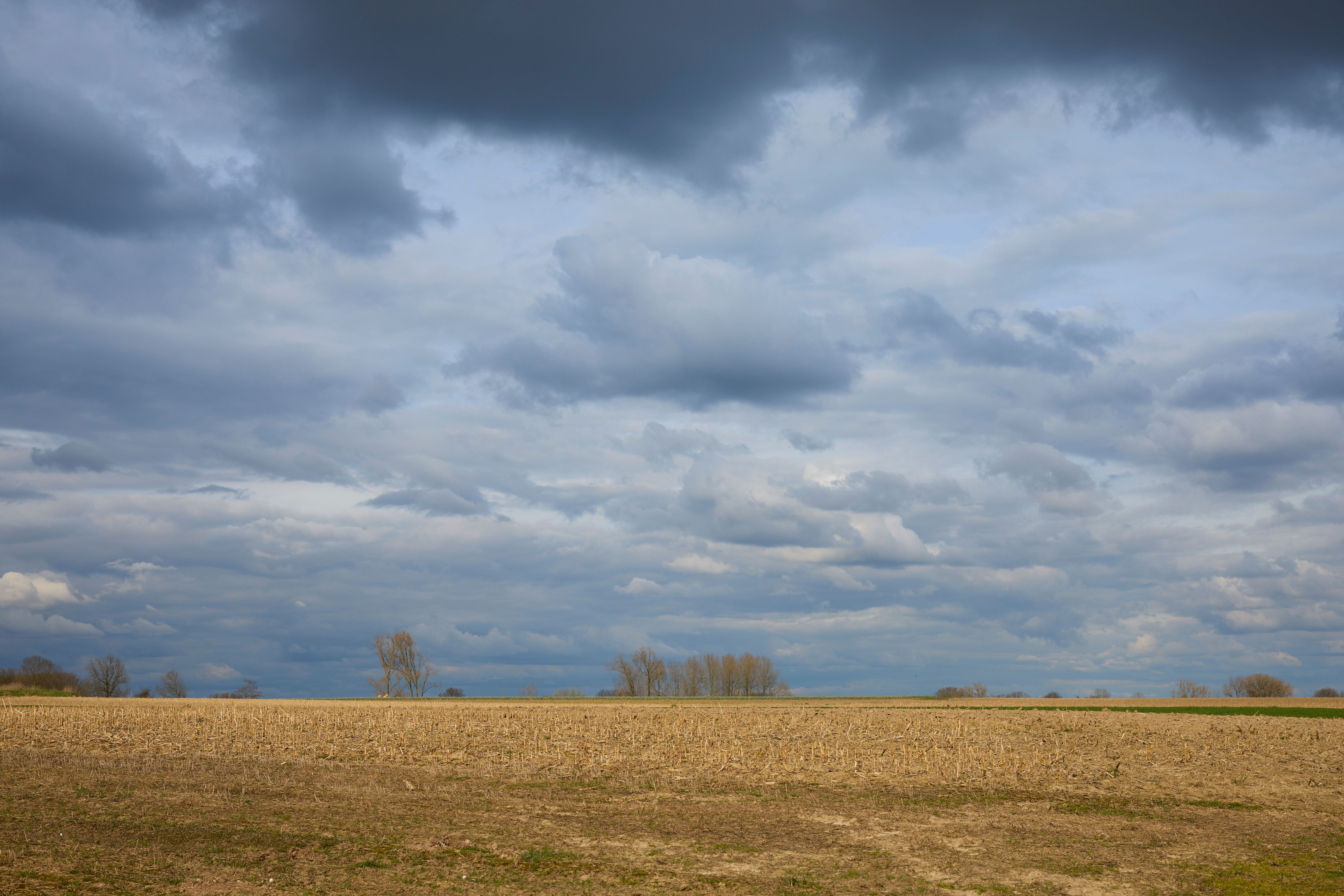 Storm clouds building over open parkland beside a river in central Ohio