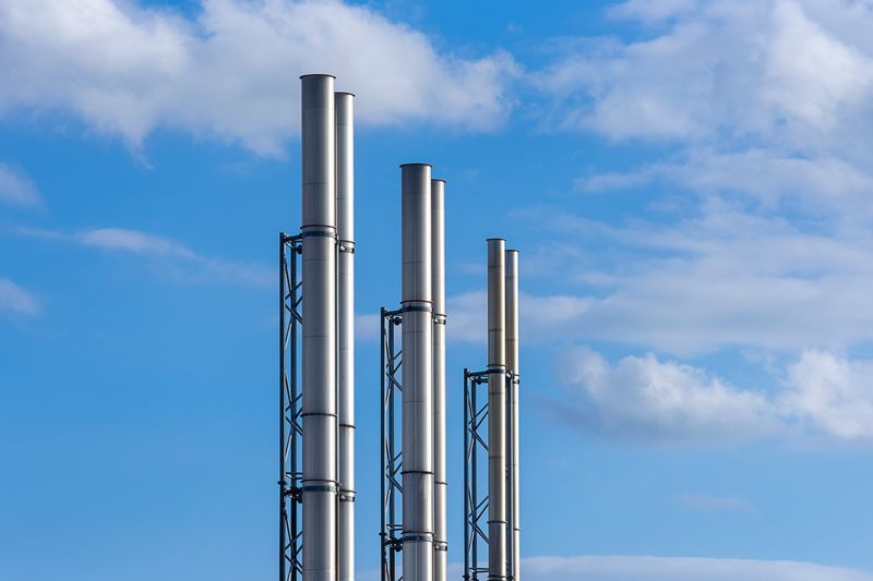 Industrial stacks against the sky