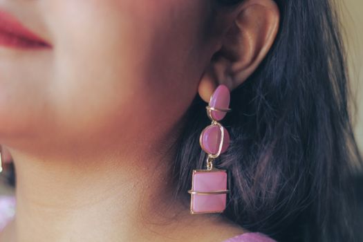 Close-up of a woman's pink earrings highlighting elegance and style, captured in Dhaka, Bangladesh.