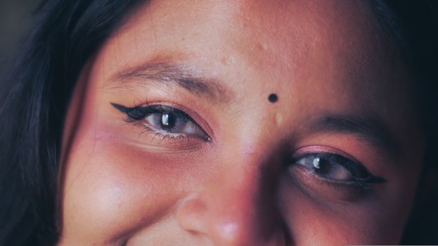 Captivating close-up of a woman's eyes and smile capturing natural beauty and elegance.
