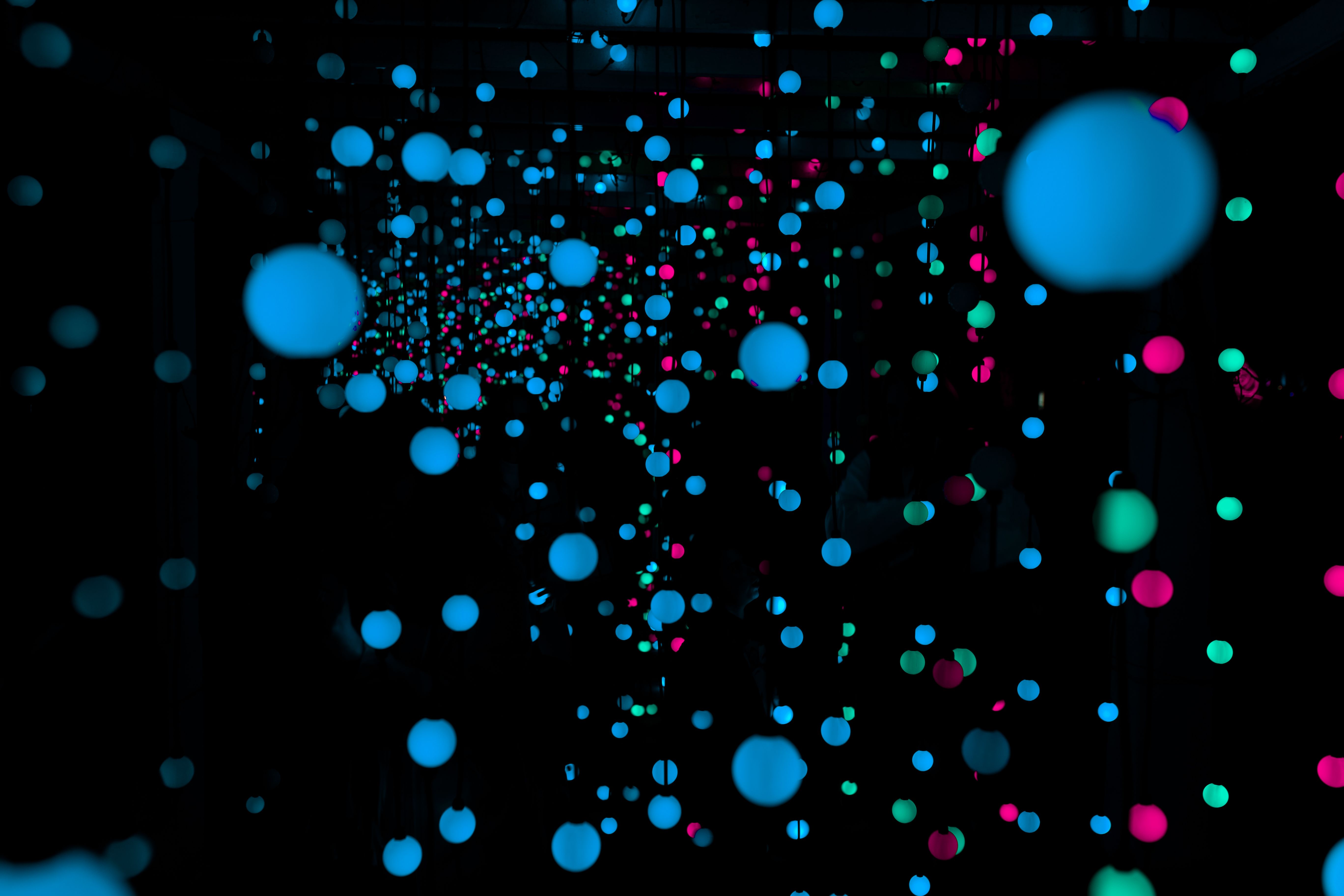 Vivid LED light installation with glowing spheres creating a surreal atmosphere.