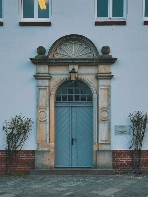 Free Elegant arched doorway with vintage architecture in Eckernförde, Germany. Stock Photo