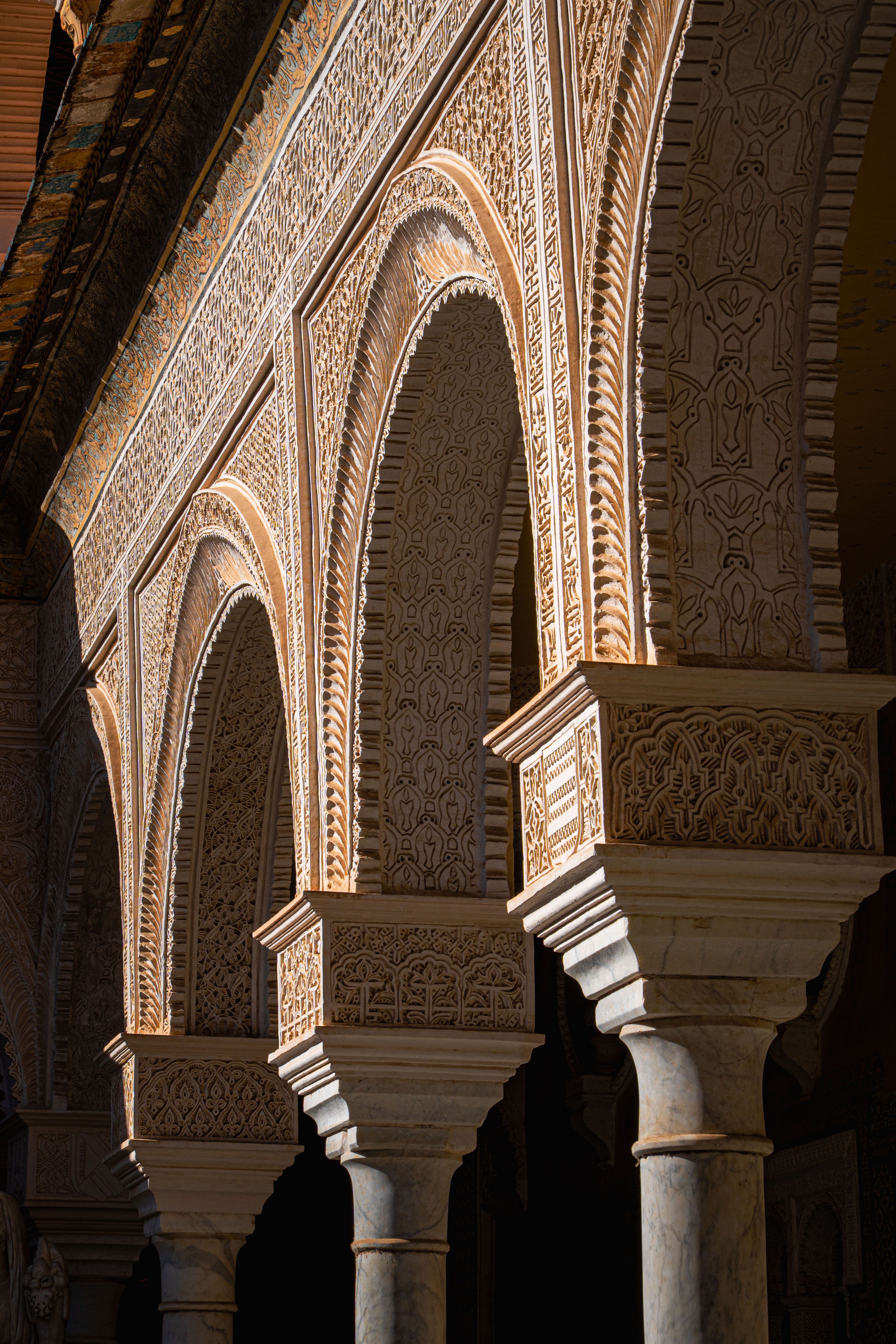 Beautifully detailed arches in the Real Alcázar of Seville, showcasing Spanish Moorish architecture.