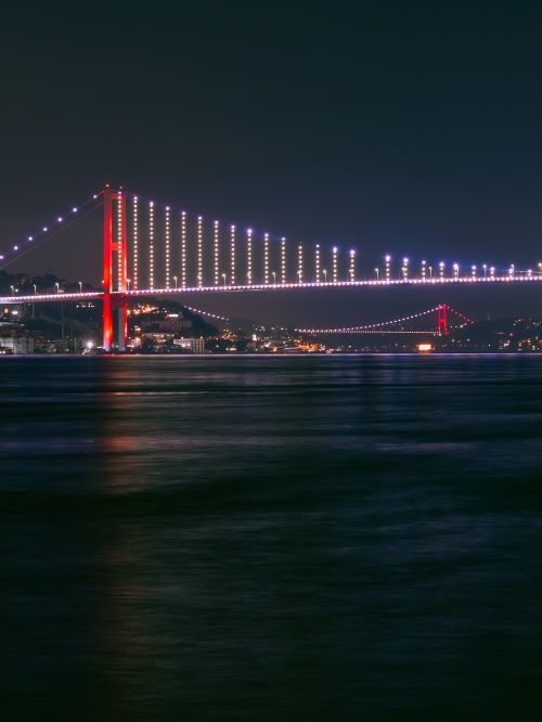 Free Night view of the illuminated Bosphorus Bridge spanning the Bosphorus Strait in Istanbul. Stock Photo