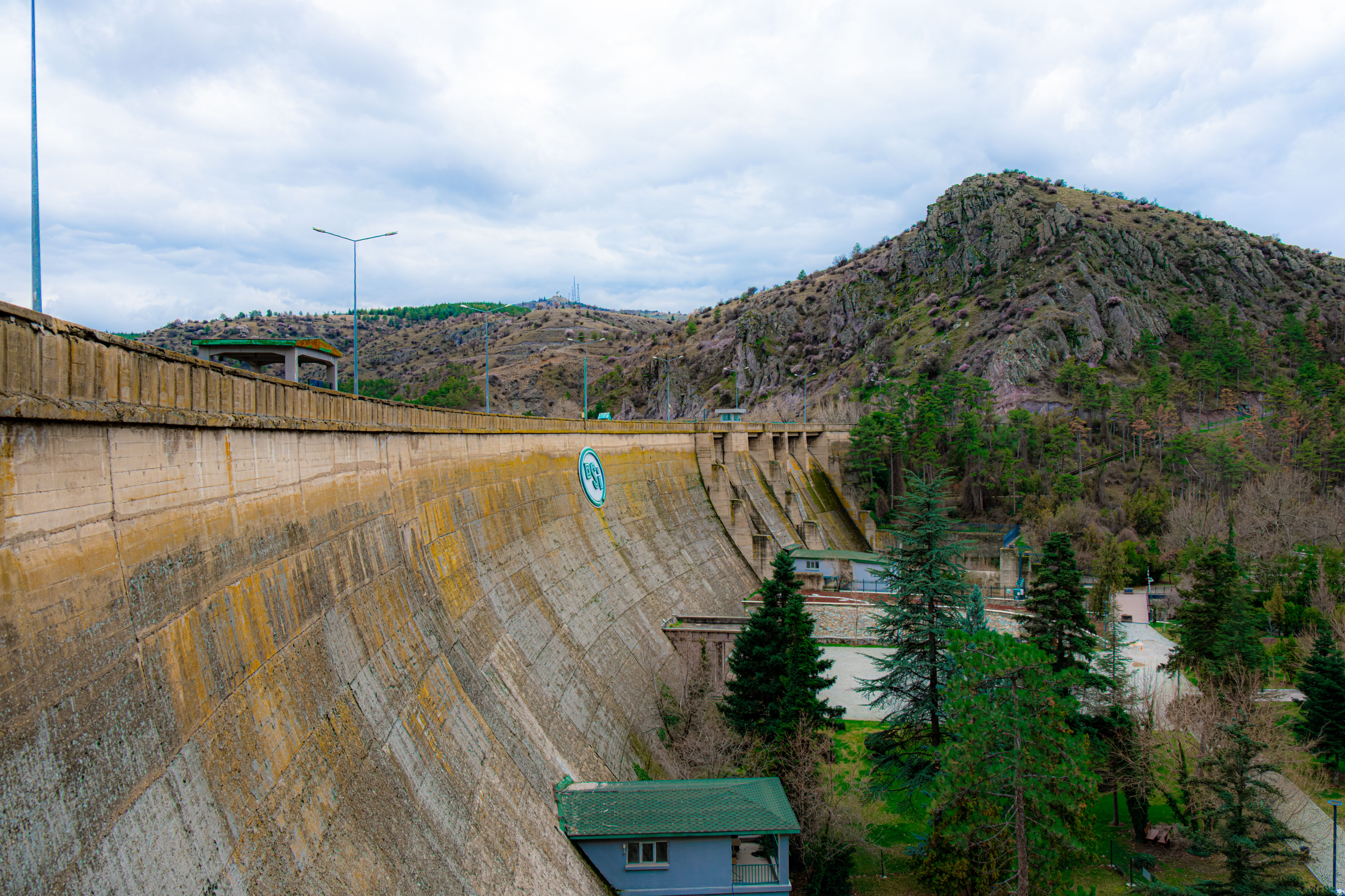 grátis Bela paisagem mostrando a barragem de Çubuk em Ancara, cercada por colinas e árvores verdejantes. Foto profissional