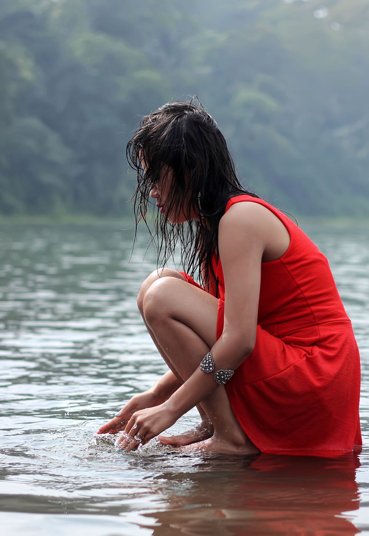 Woman Sitting on Rock in Body of Water · Free Stock Photo
