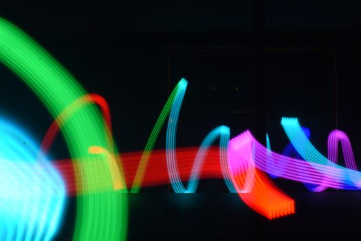 Colorful light trails creating abstract patterns on a dark background, ideal for creative projects.