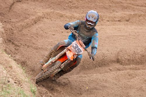 Free Motocross rider expertly maneuvers through a dirt track, showcasing skills and speed. Stock Photo