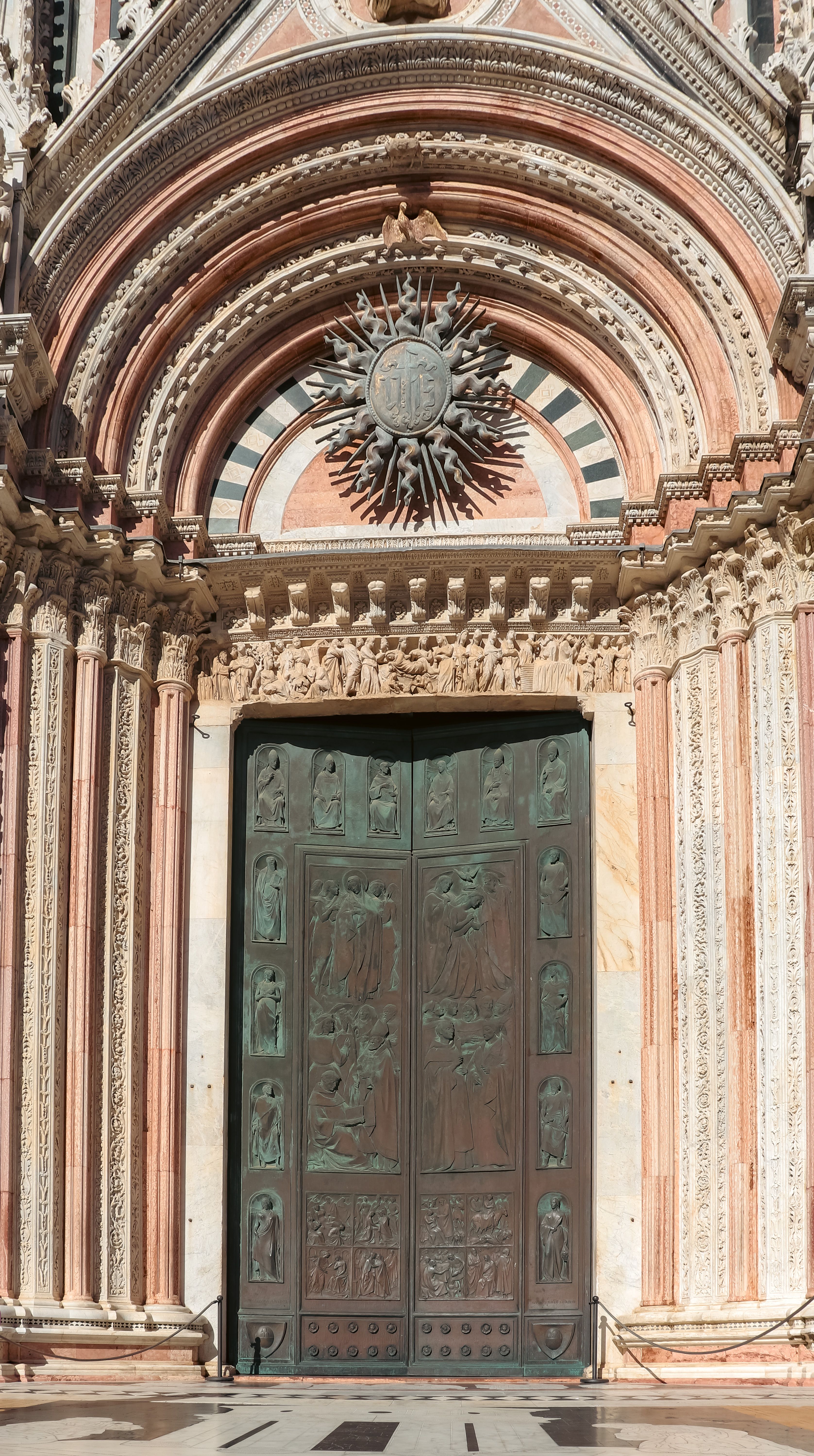 Stunning detailed view of Florence Cathedral's ornate door facade in Tuscany, Italy.