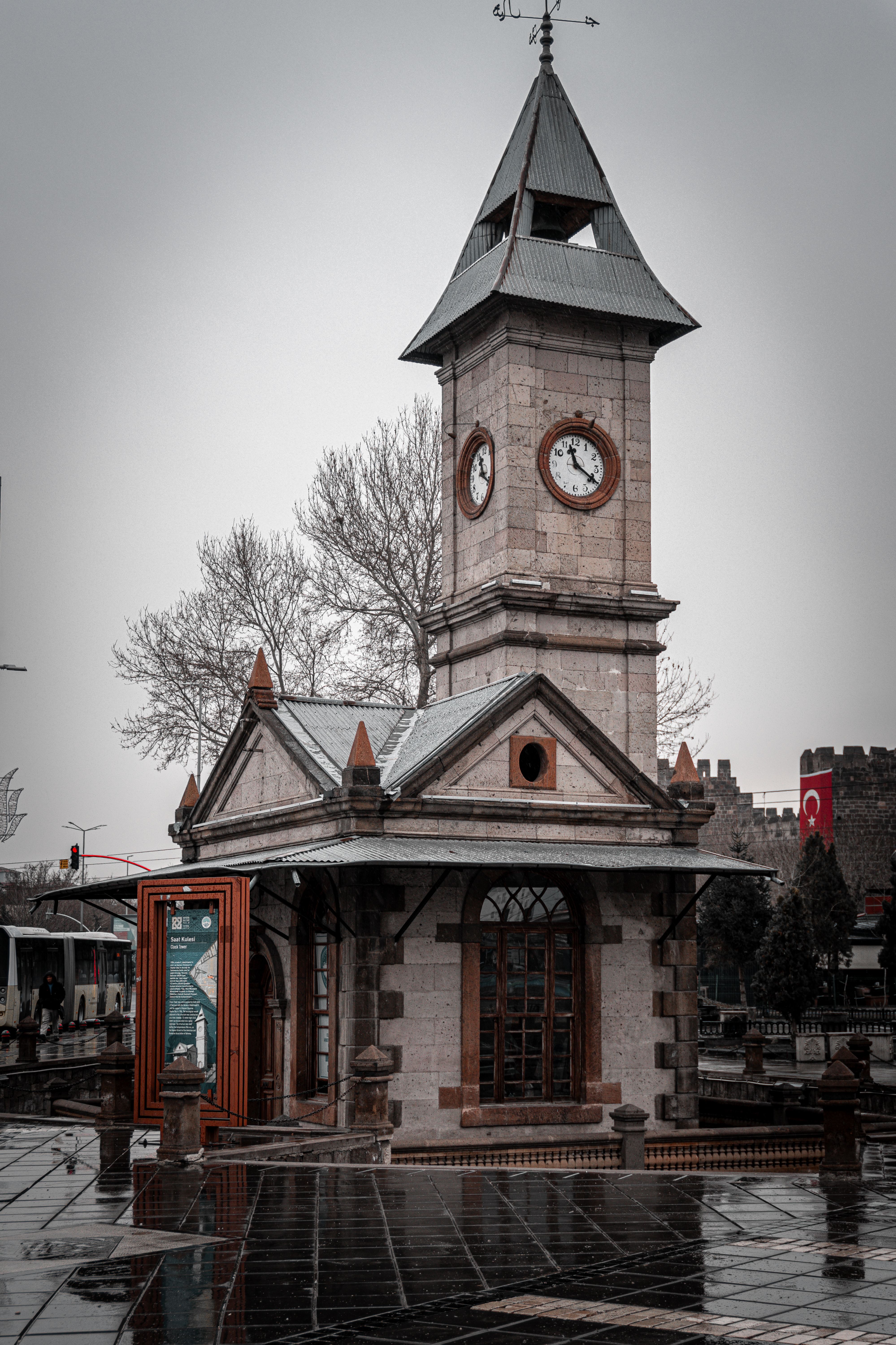 A classic stone clock tower captured on a cloudy day in Kayseri, Türkiye, showcasing traditional architecture.