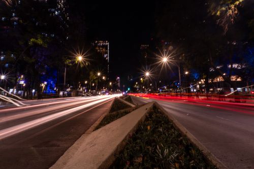 Free Long exposure of busy night traffic on a major boulevard in Mexico City, highlighting vibrant lights. Stock Photo