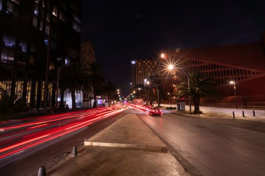 Dynamic long exposure of traffic lights and cityscape in Mexico City at night, showcasing urban vibrancy.