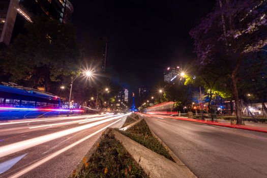 Captivating night scene in Mexico City featuring light trails and urban architecture.